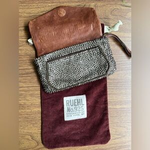 Ruehl 925 genuine leather clutch with metal sequin and beading details.